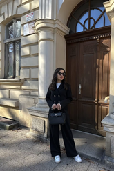 a lady in a white top, a double-breasted jacket and a pair of black micro-flared pants